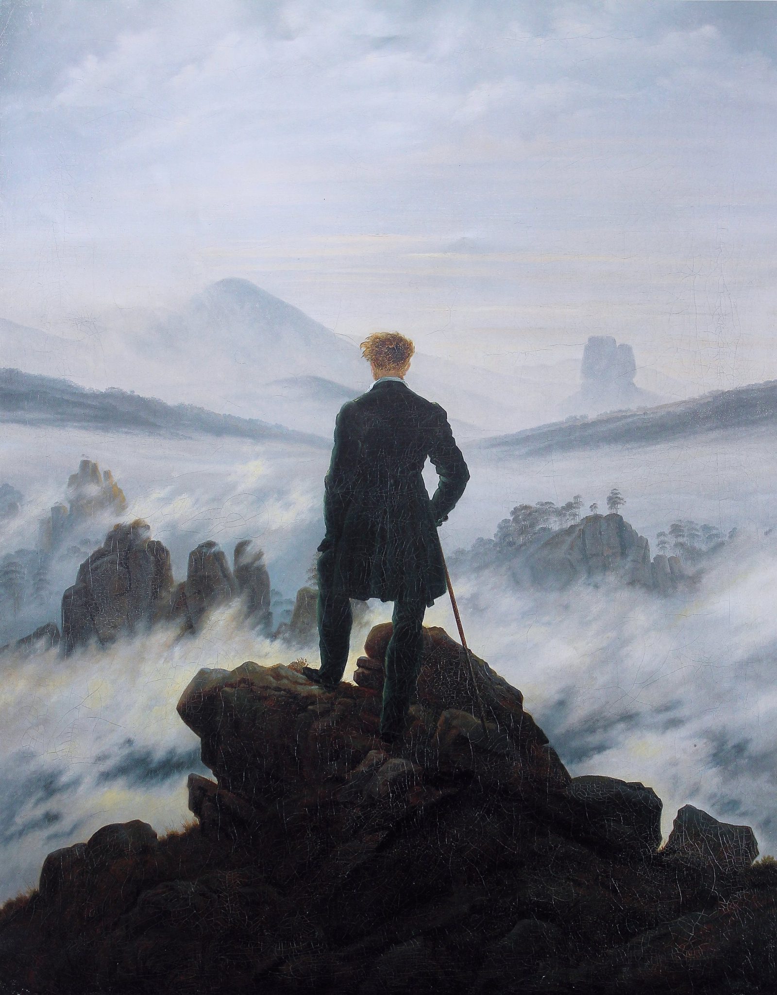 Caspar David Friedrich's 1818 painting Wanderer Above the Sea of Fog, showing a man standing on a rocky summit looking over a sea of cloud toward distant mountain ridges.