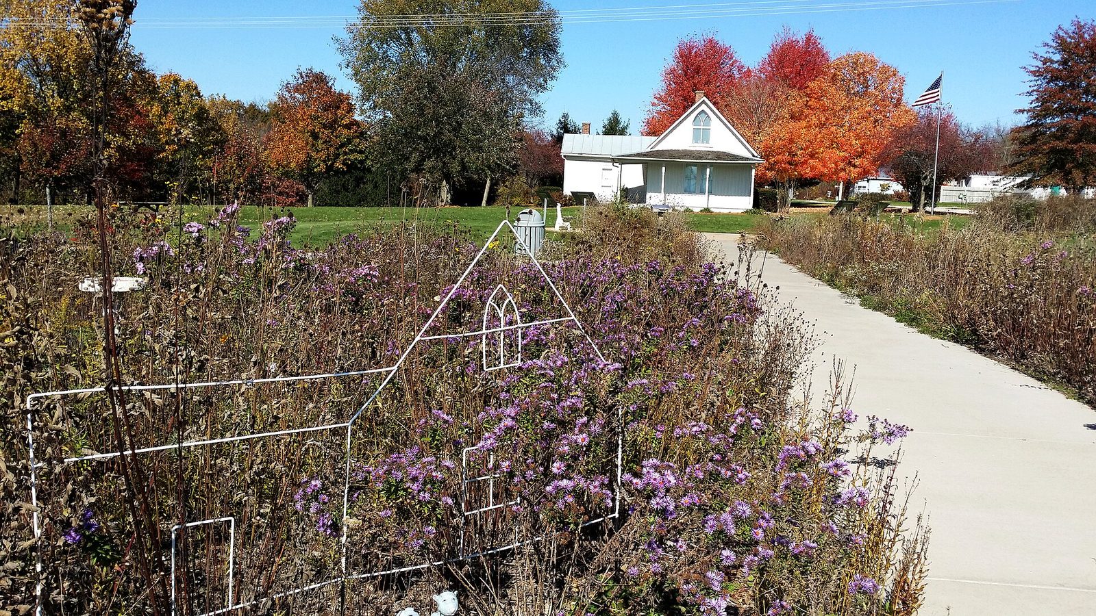 The American Gothic House in Eldon, Iowa, the Carpenter Gothic farmhouse Grant Wood used as the backdrop for American Gothic. The painting itself is not reproduced here.