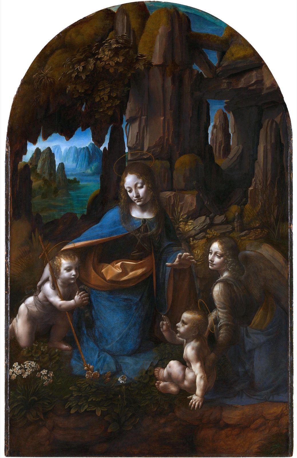 Leonardo da Vinci's Virgin of the Rocks as it hangs today in the National Gallery, London, showing the Virgin, the infant Christ, the infant John the Baptist and an angel grouped in a rocky grotto, the composition Leonardo settled on after abandoning at least one earlier design underneath it.