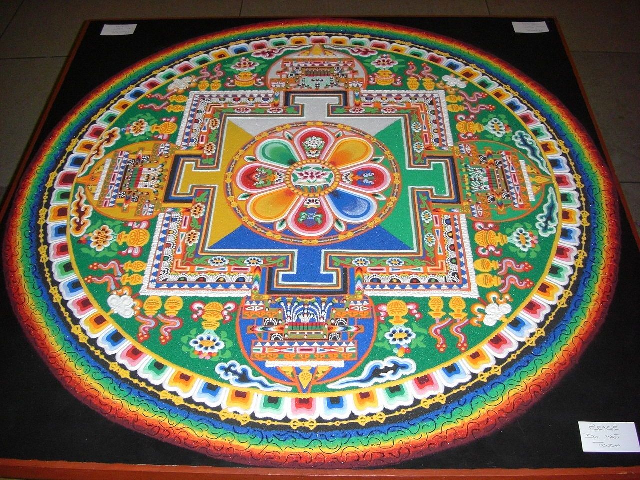 A completed Chenrezig sand mandala on display inside the Palace of Westminster in London, built to mark the Dalai Lama's May 2008 visit and later ritually dismantled.