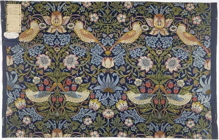 Strawberry Thief, an 1883 indigo-discharged and block-printed cotton textile by William Morris, showing thrushes stealing strawberries among stylized flowers and foliage in a repeating pattern.