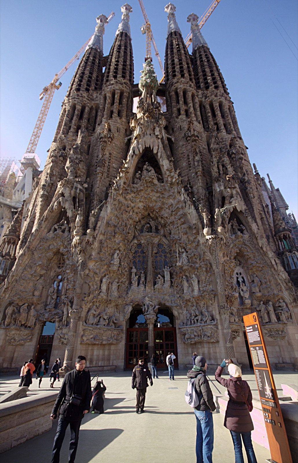 The Nativity Façade of Sagrada Família, densely carved with naturalistic sculpture of plants, animals, and biblical figures, the section of the basilica completed largely under Antoni Gaudí's own supervision.