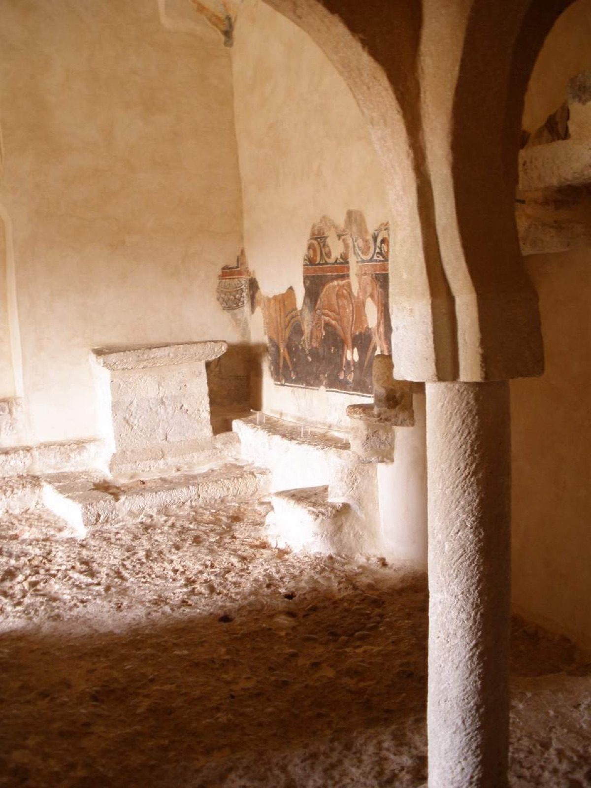 The interior of the eleventh-century hermitage of San Baudelio de Berlanga in Soria, Castile, whose central column and vaulted ceiling remain, but whose Romanesque murals were removed and sold abroad in 1926.