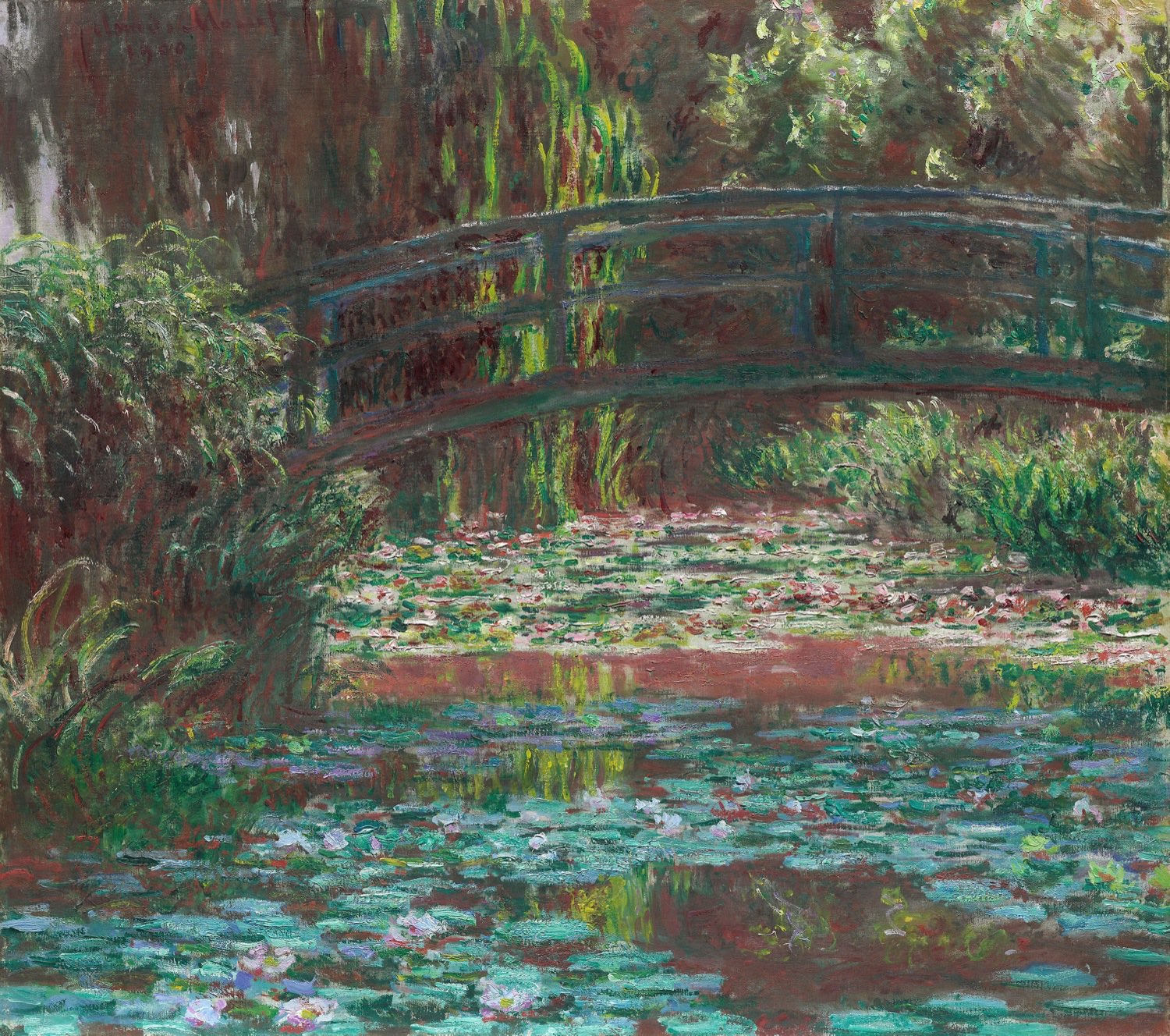 Monet's Water Lily Pond of 1900, showing the green Japanese footbridge arching over a pond crowded with pink and white lilies