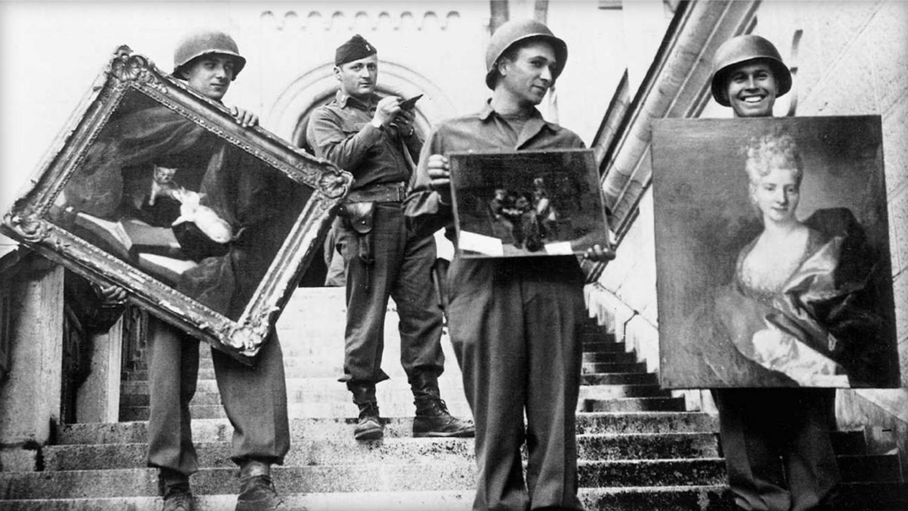 U.S. Monuments Men officers and recovered paintings stacked in Neuschwanstein Castle, Germany, 1945.